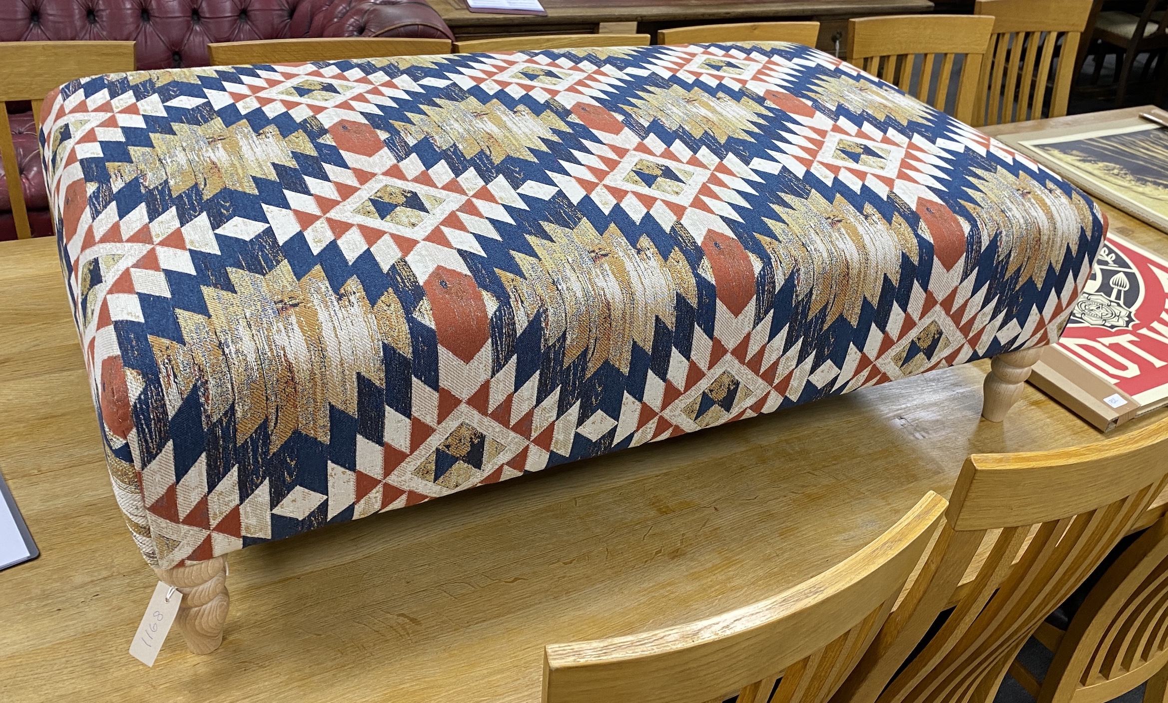 A large contemporary rectangular footstool upholstered in Kilim style polychrome fabric on turned beech feet, length 124cm, depth 75cm, height 38cm